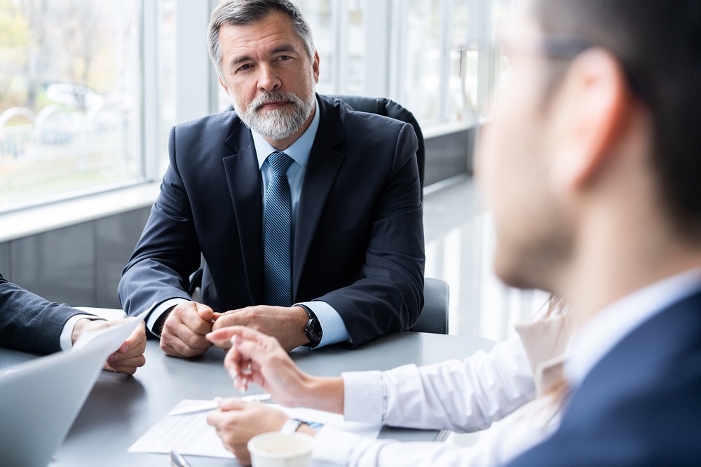 Businesspeople discussing together in conference room during meeting at office.