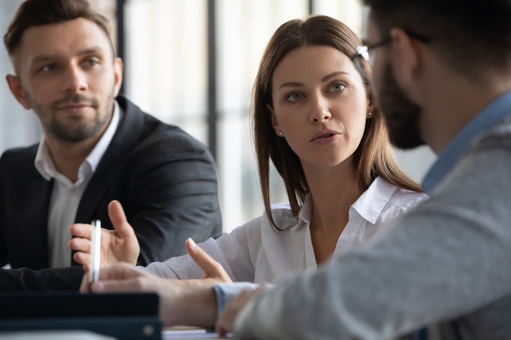 Attractive manager businesswoman conducts coaching in boardroom.