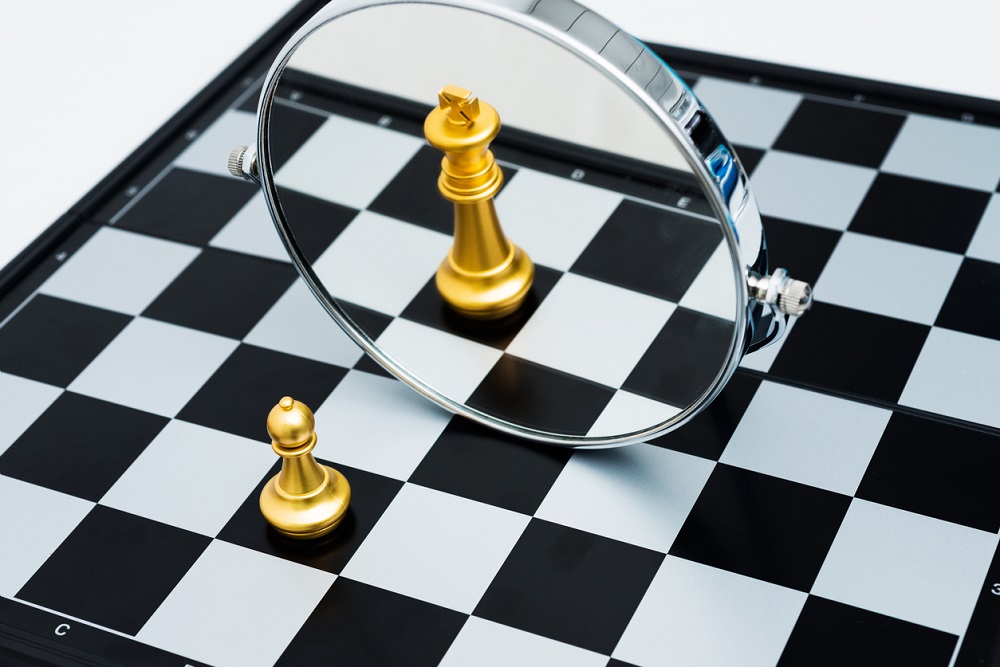 Golden chess pawn imagining itself as a king