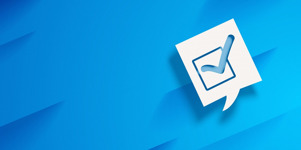 Check Box Ok Sign in White Speech Bubble on Blue Abstract Background