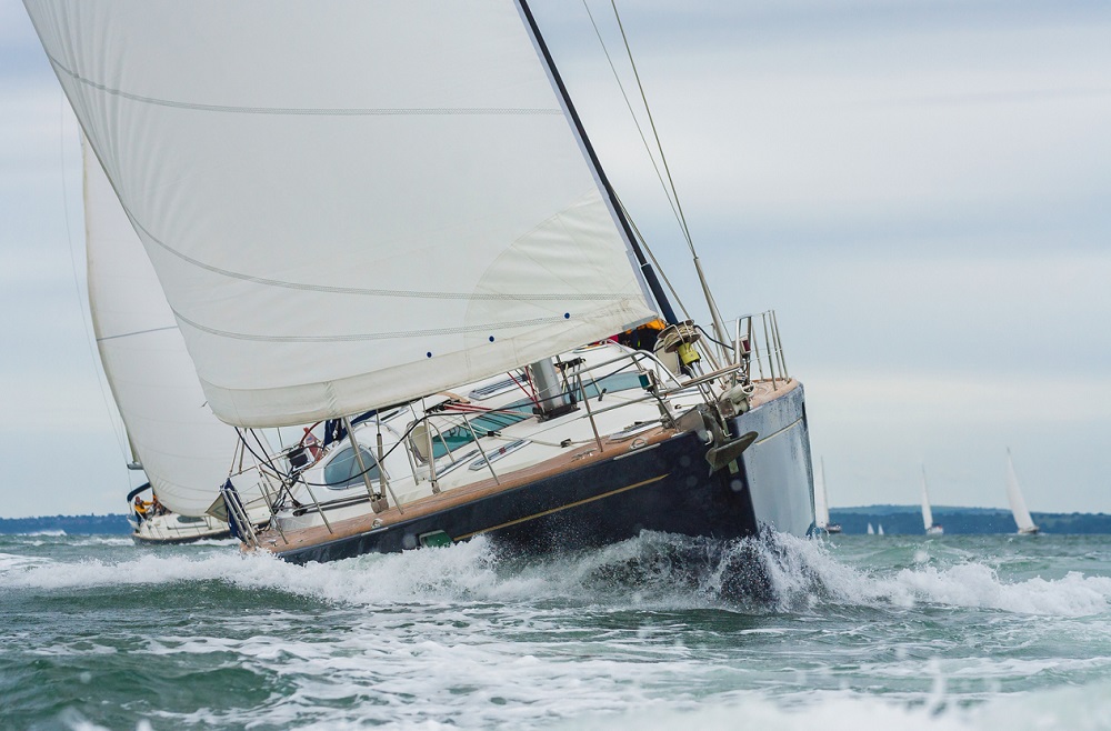 Two sailing boats, sail boats or yachts racing at sea