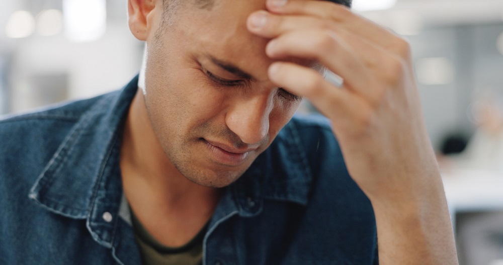 Man, face and headache in mistake, stress or burnout from mental health problems at office. Frustrated male person or tired employee with migraine, anxiety or depression in financial crisis or debt
