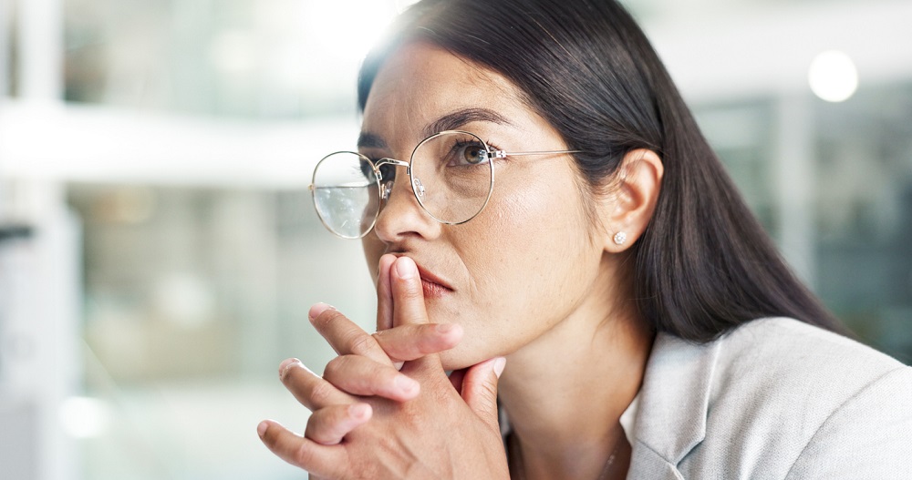 Business, woman and thinking with stress at company for job interview, recruitment or hiring news. Employee, professional person and anxiety at workplace for onboarding decision and waiting in lobby